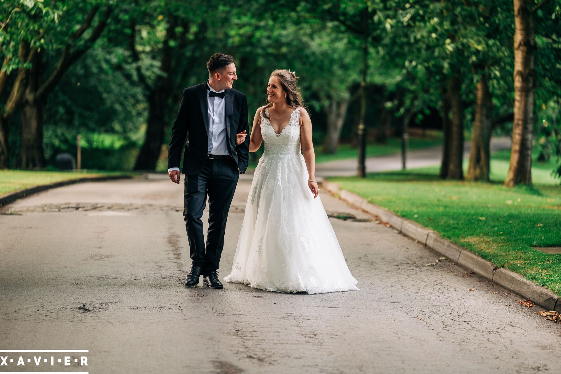 bride and groom walk hand in hand on the driveway at Oulton hall Hotel