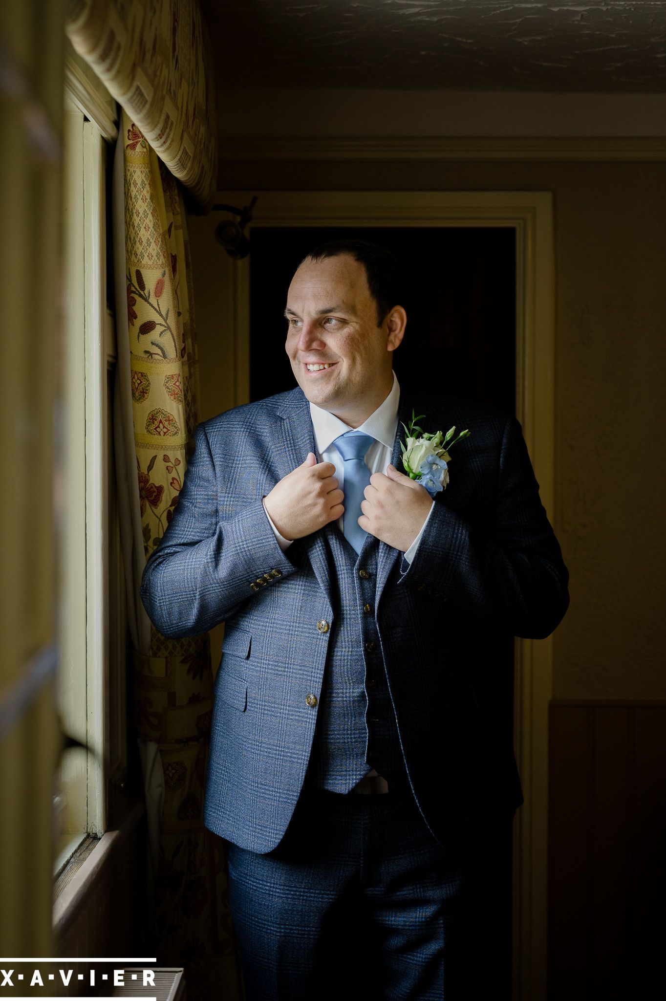 groom looks out of the window