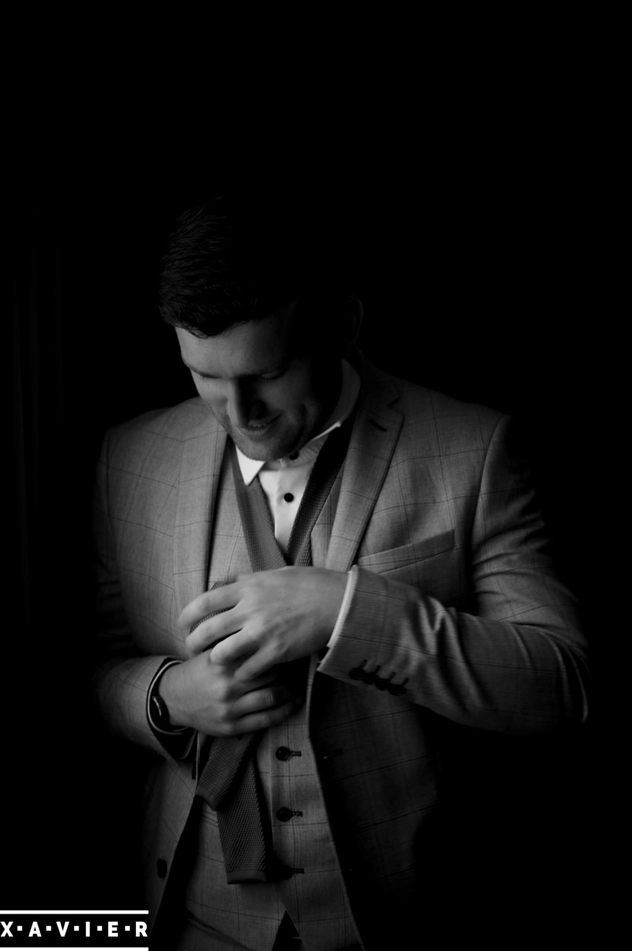 groom tying his tie