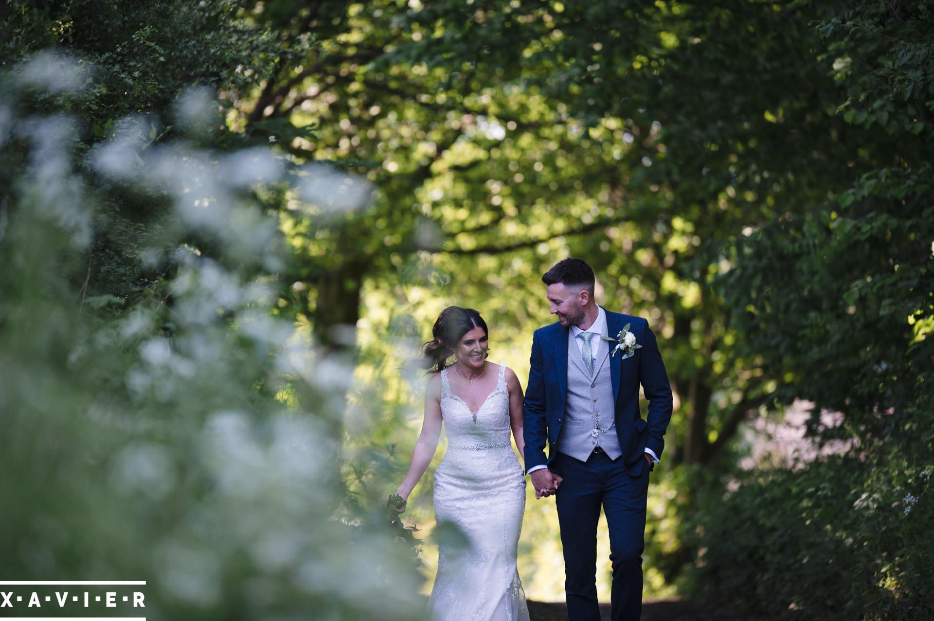 bride and groom walking along the country lane