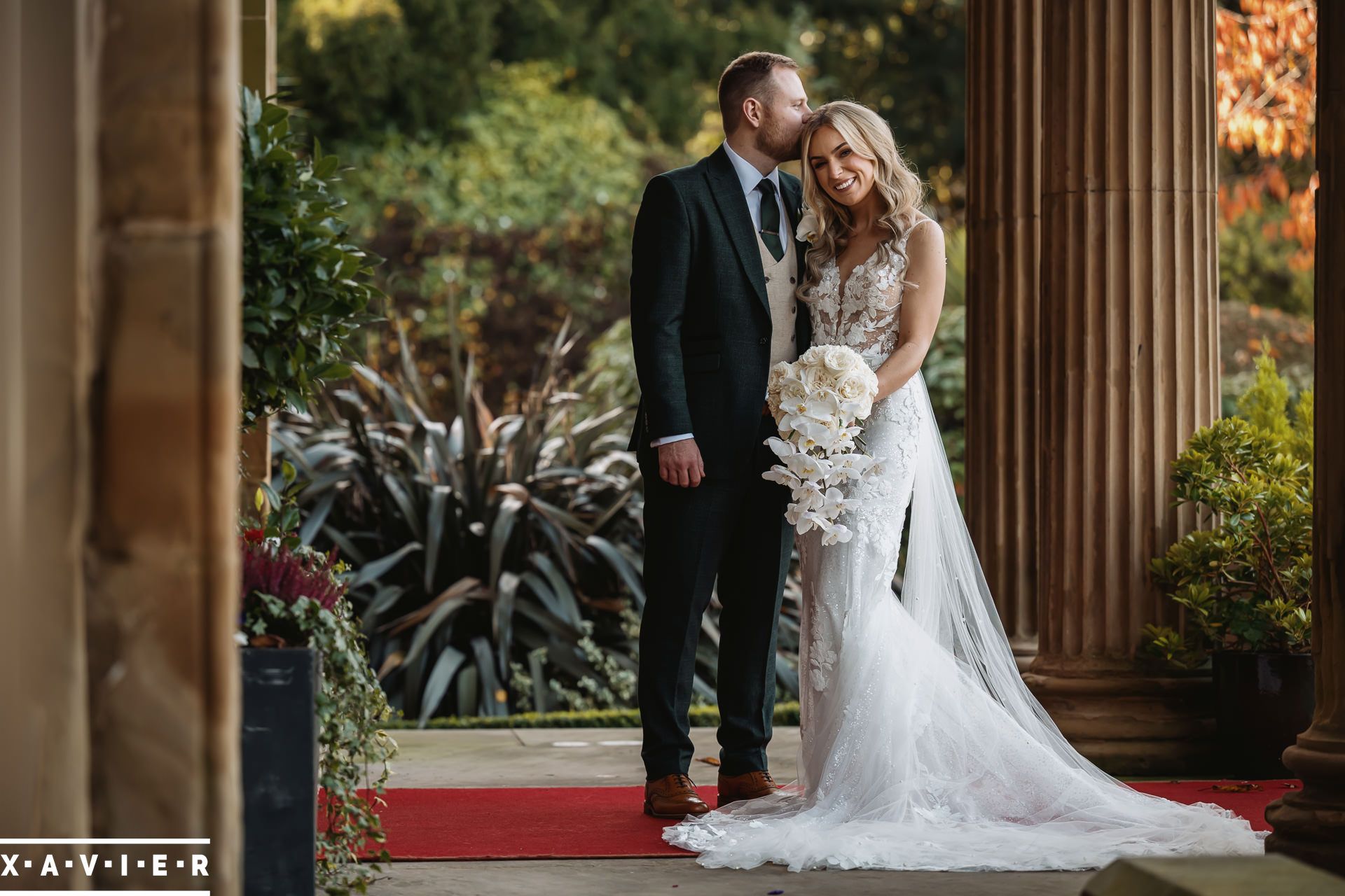 bride and groom wkiss at the front door