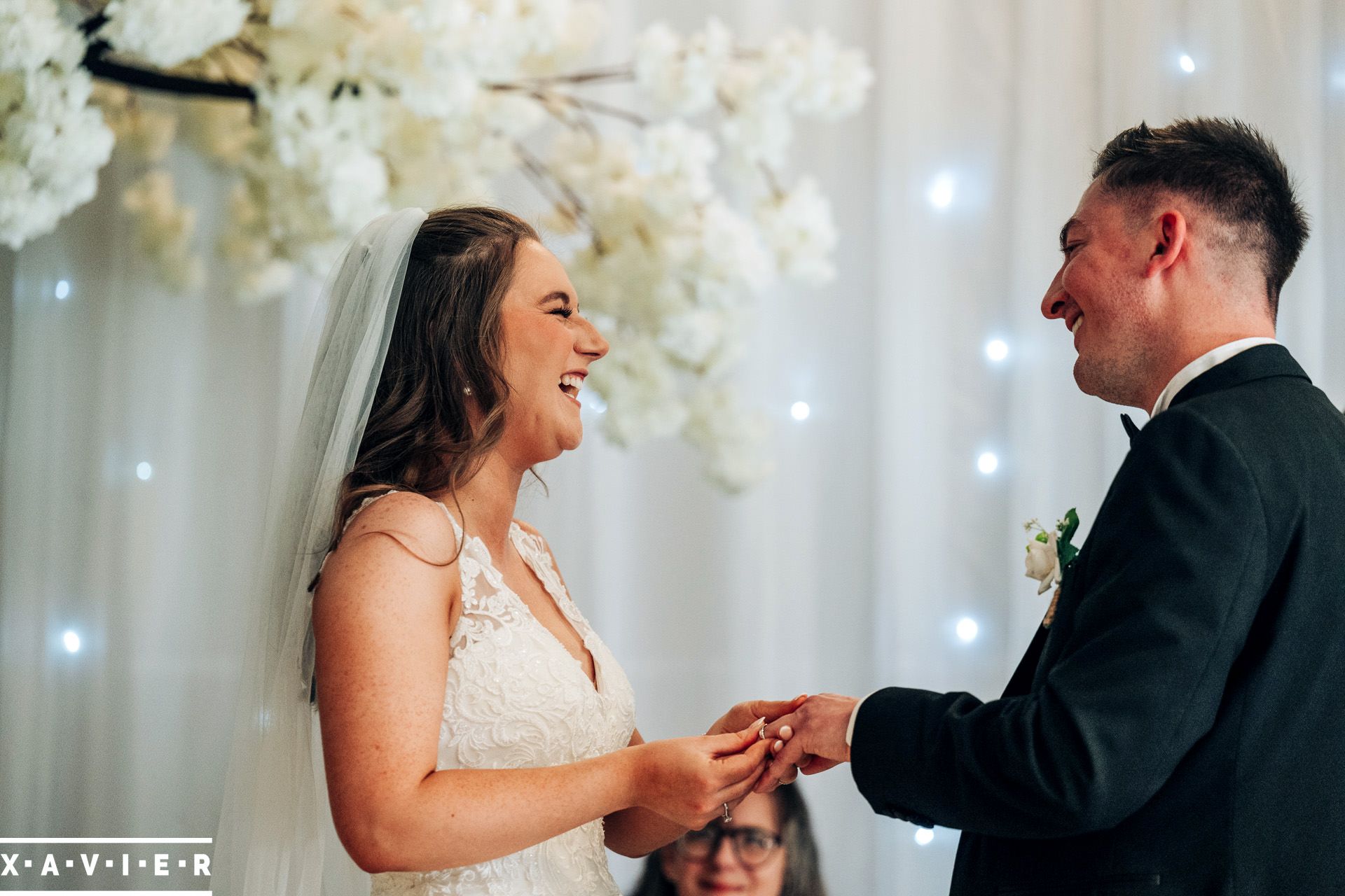 bride and groom exchange rings during the ceremony