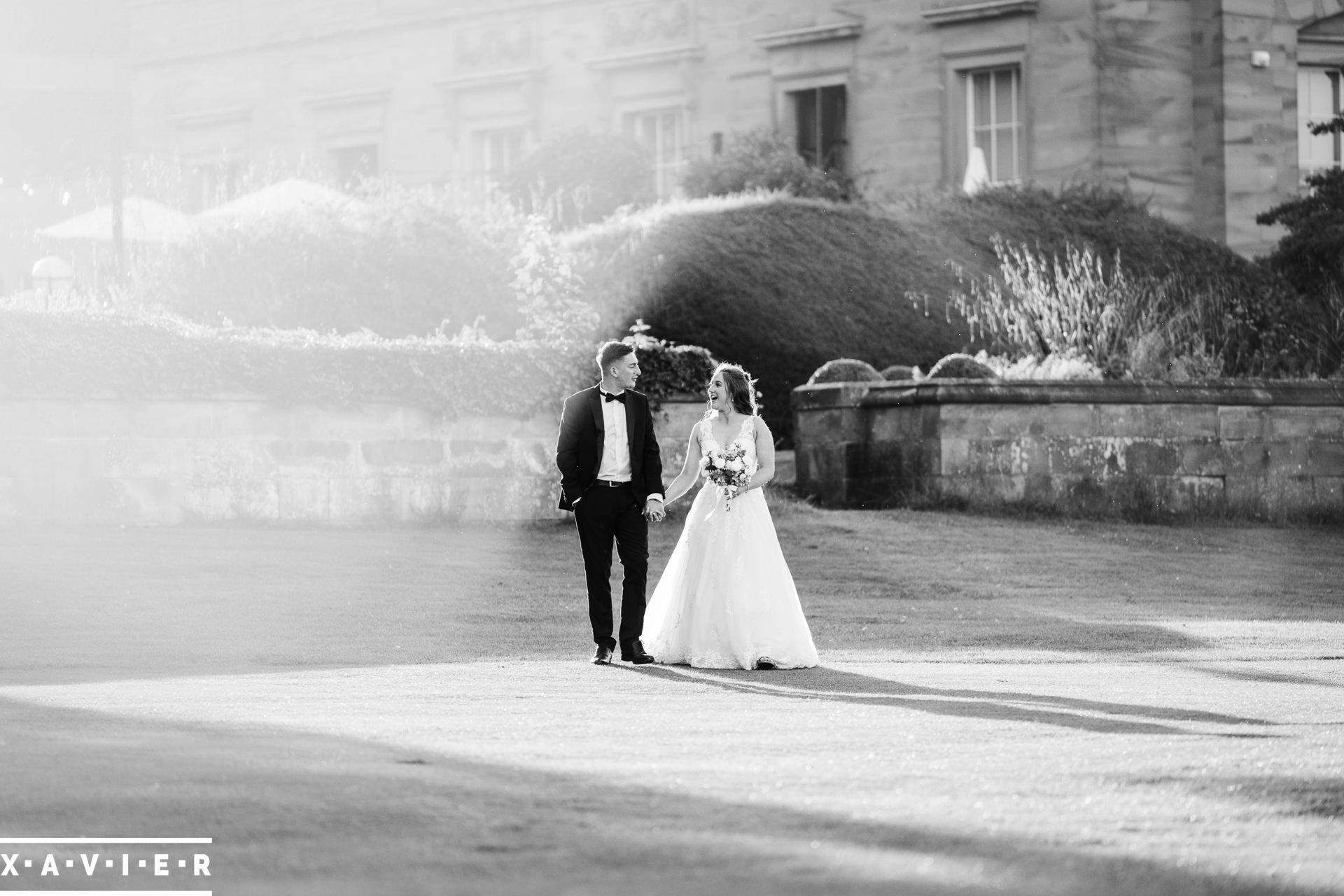 bride and groom walk in the grounds of oulton hall hotel