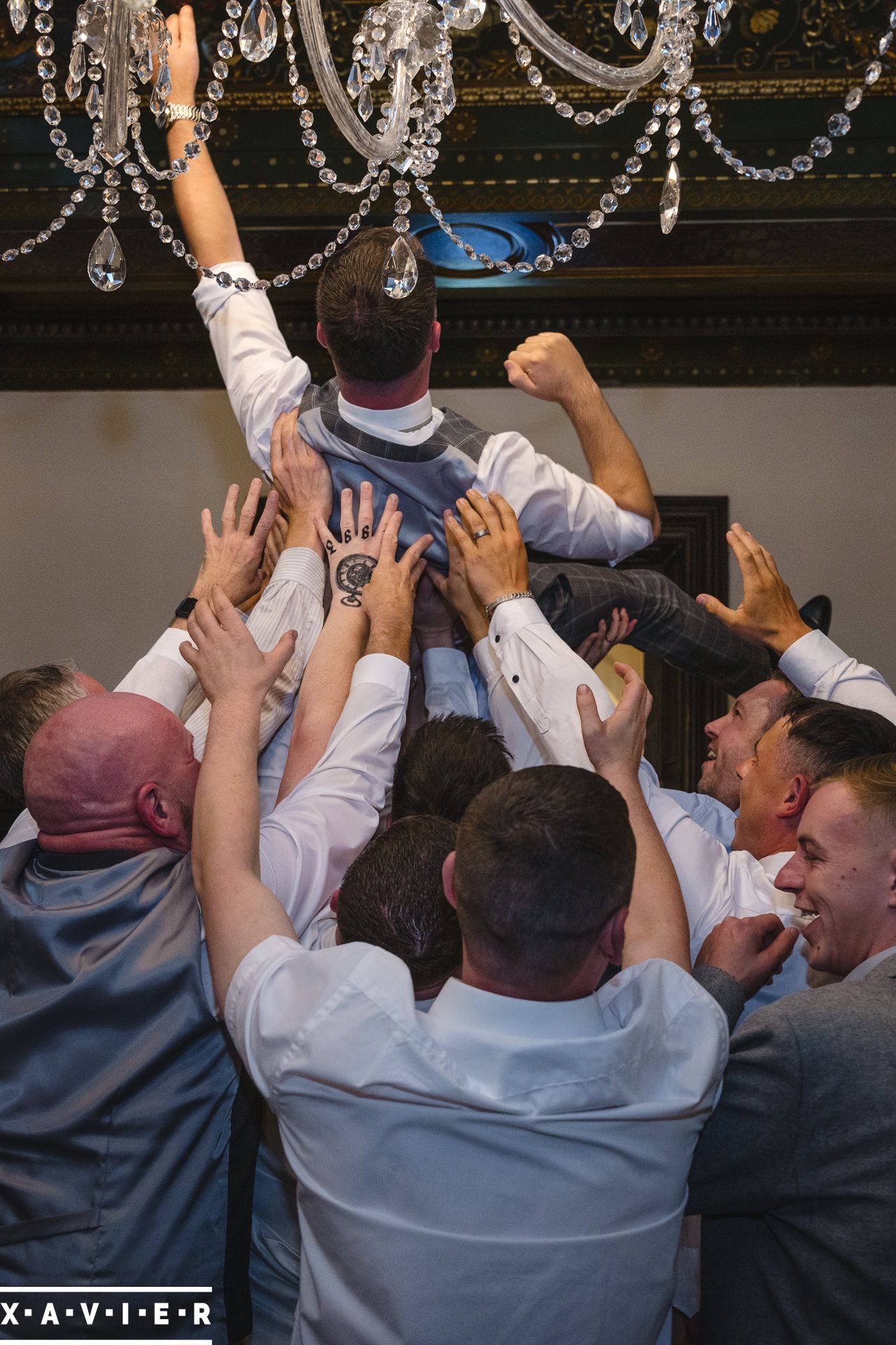 Groomsmen pick up the groom