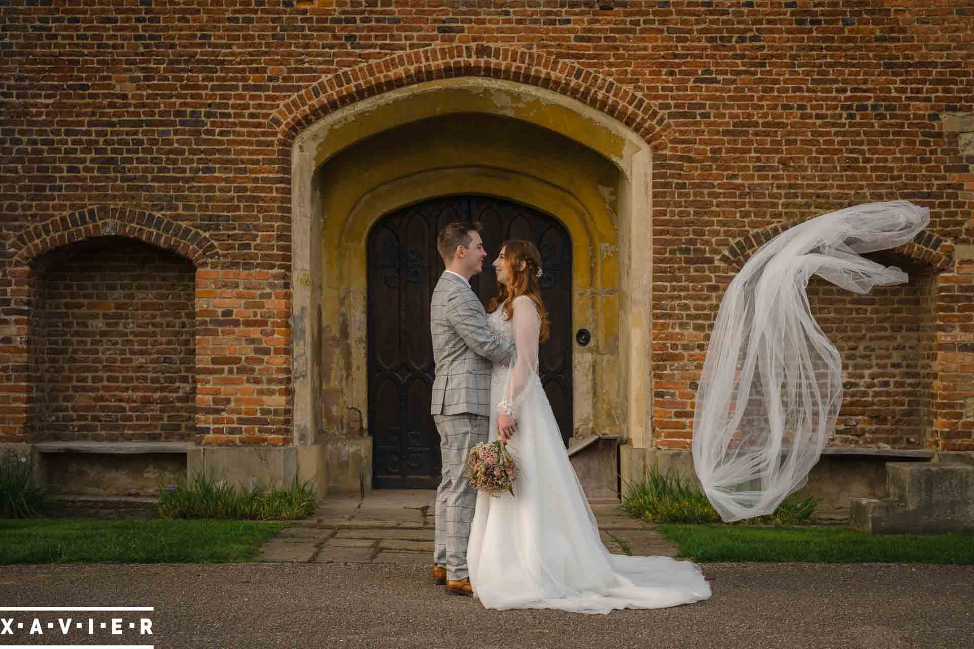 The veil has blown off the brides head